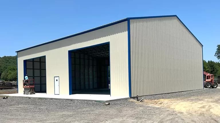 60×70 commercial clear-span steel building under a bright summer sky
